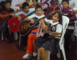 Lepeley Foundation children playing guitar